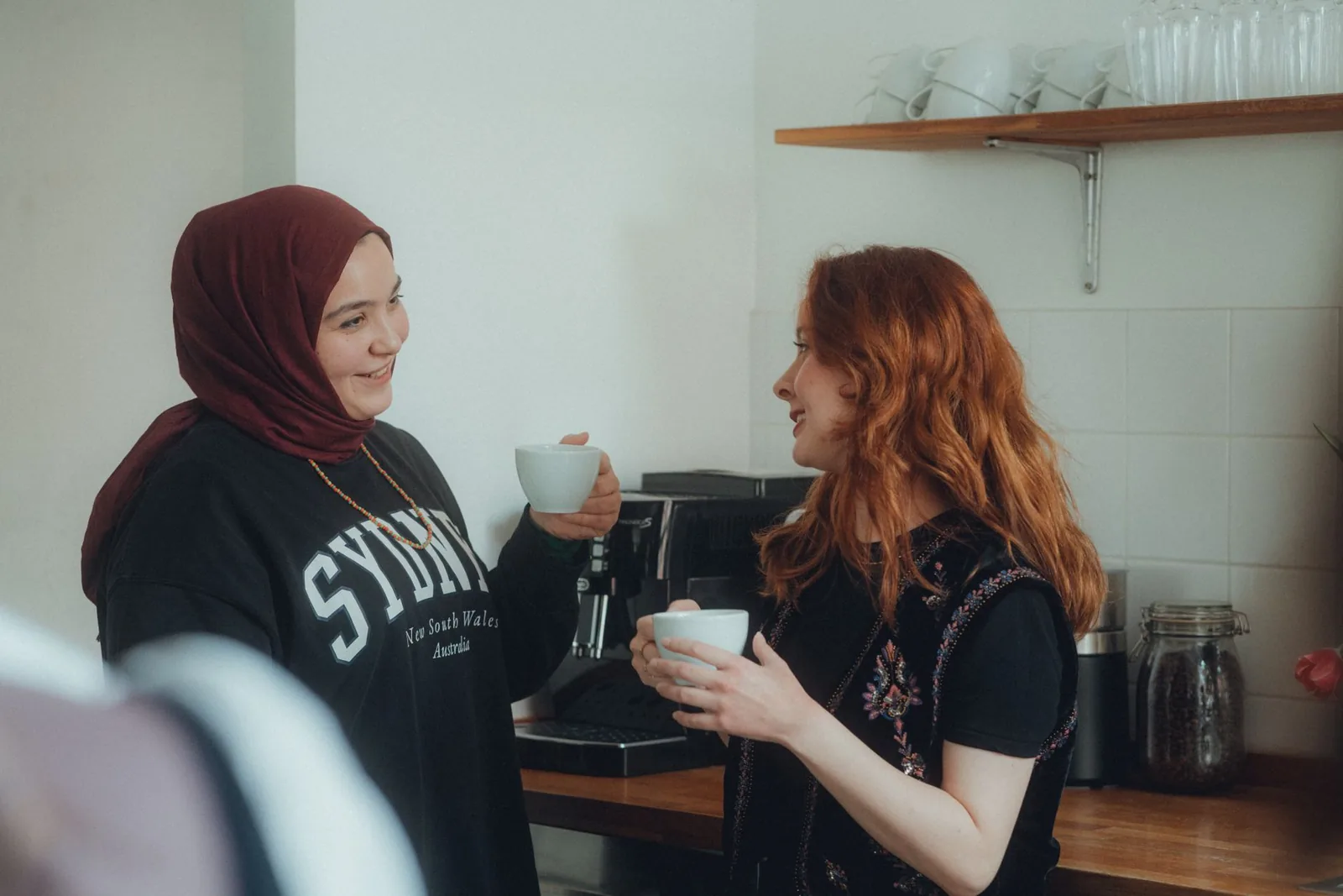 Twee vrouwen in een ontspannen gesprek in een lichte ruimte